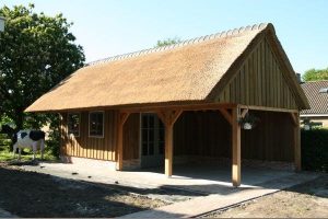 red cedar berging met veranda en rieten kap